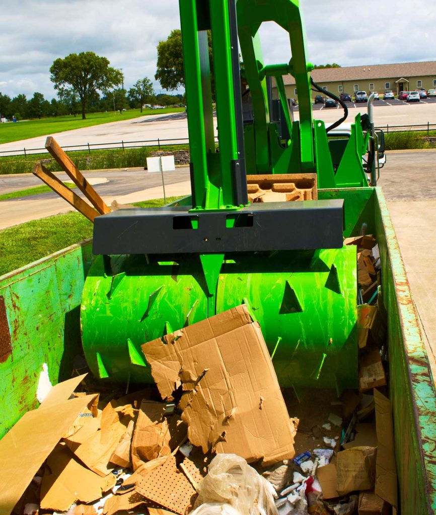Crushr's Commercial Garbage Compactor Crushing Garbage in a Dumpster